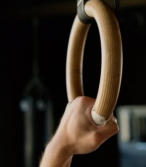 Close-up of a hand gripping the floor during an exercise.